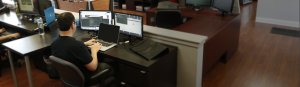 back of employee working at a desk