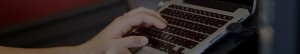 Close up of hands on a latptop keyboard