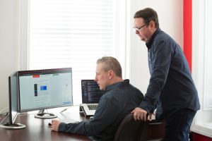 Two men looking at a computer