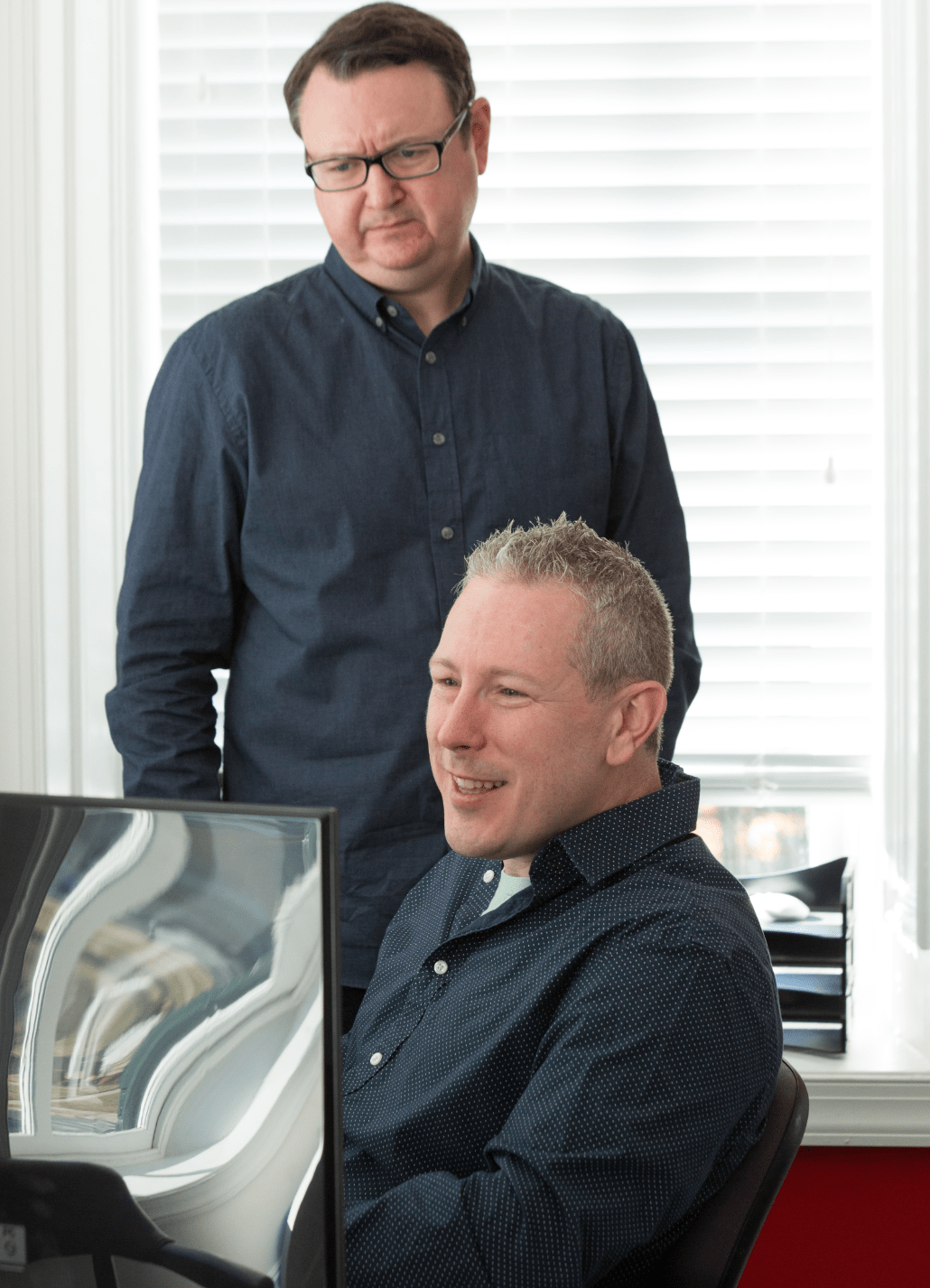 two men looking at a computer screen