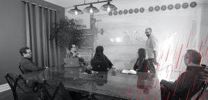 man presenting to a conference room of employees