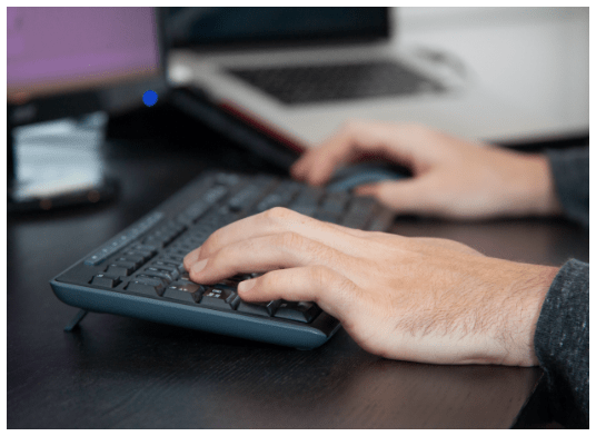 close up of hands on a keyboard