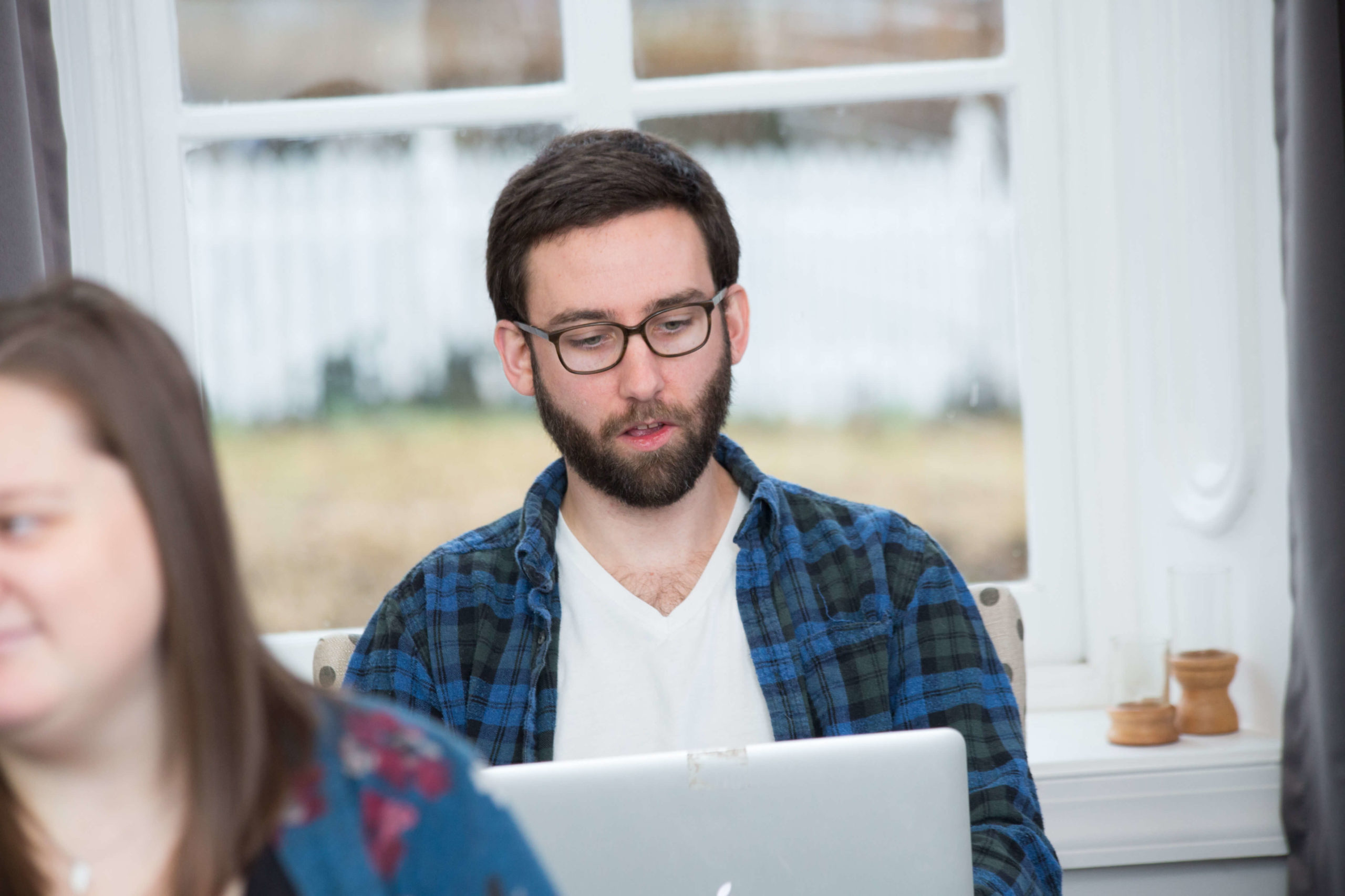 man on laptop in front of window