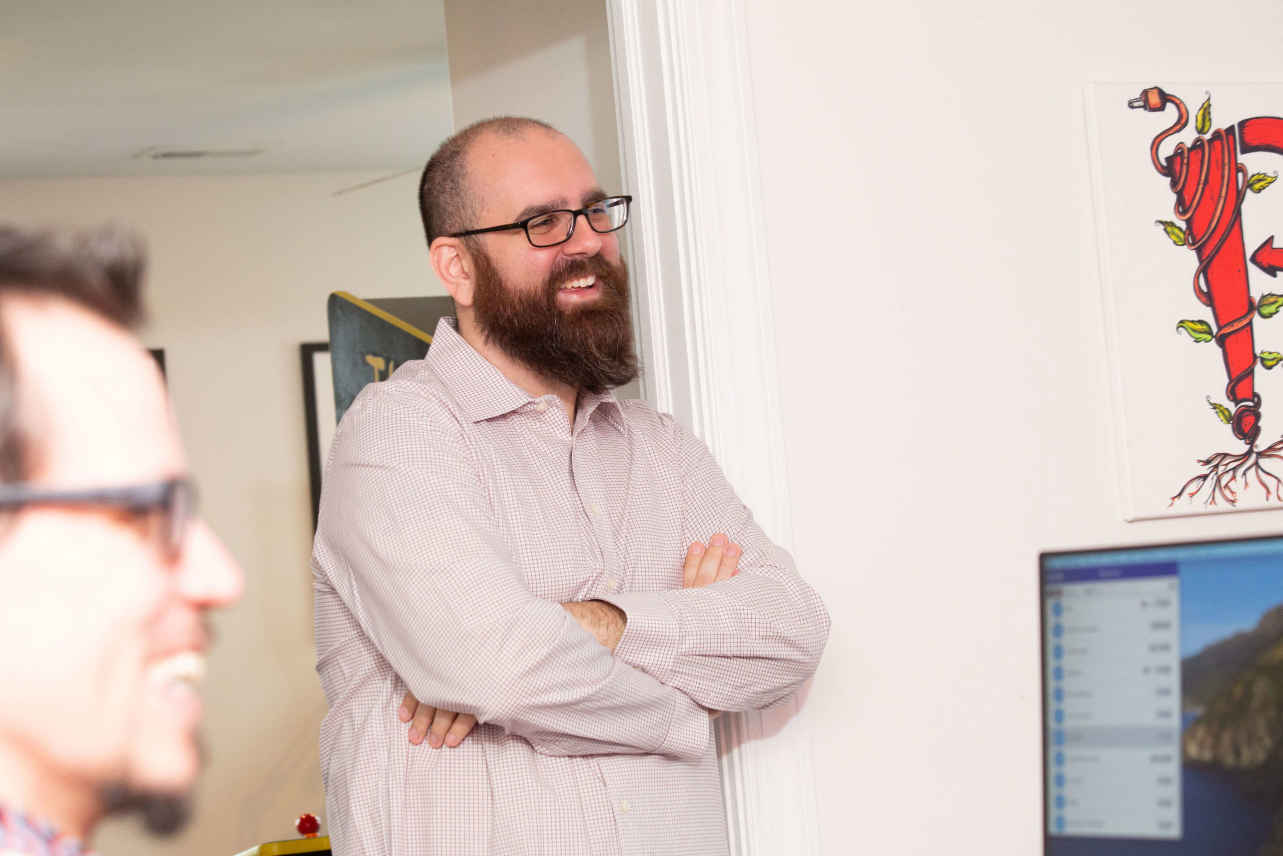 man standing in doorway laughing