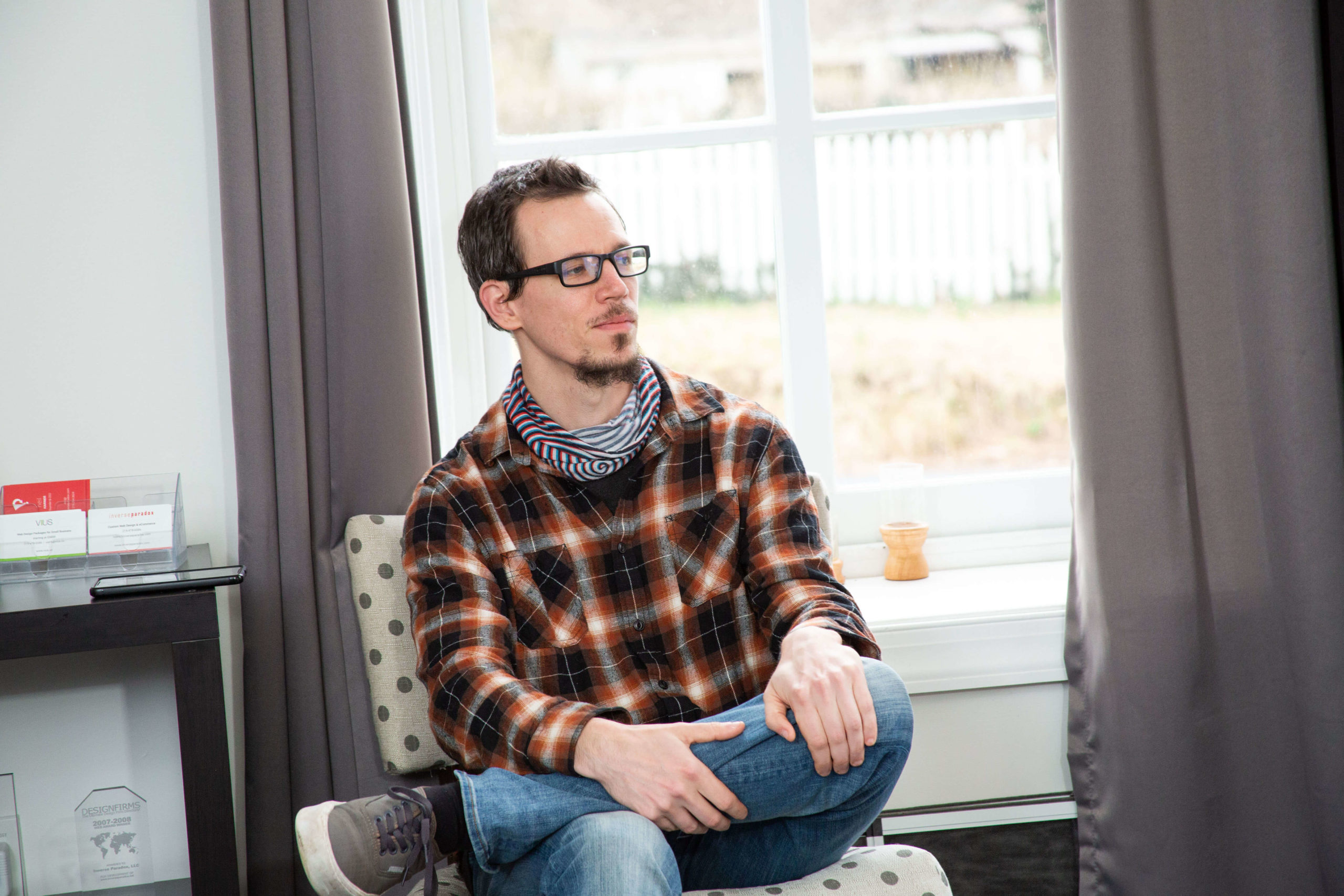 man sitting on a chair by a window