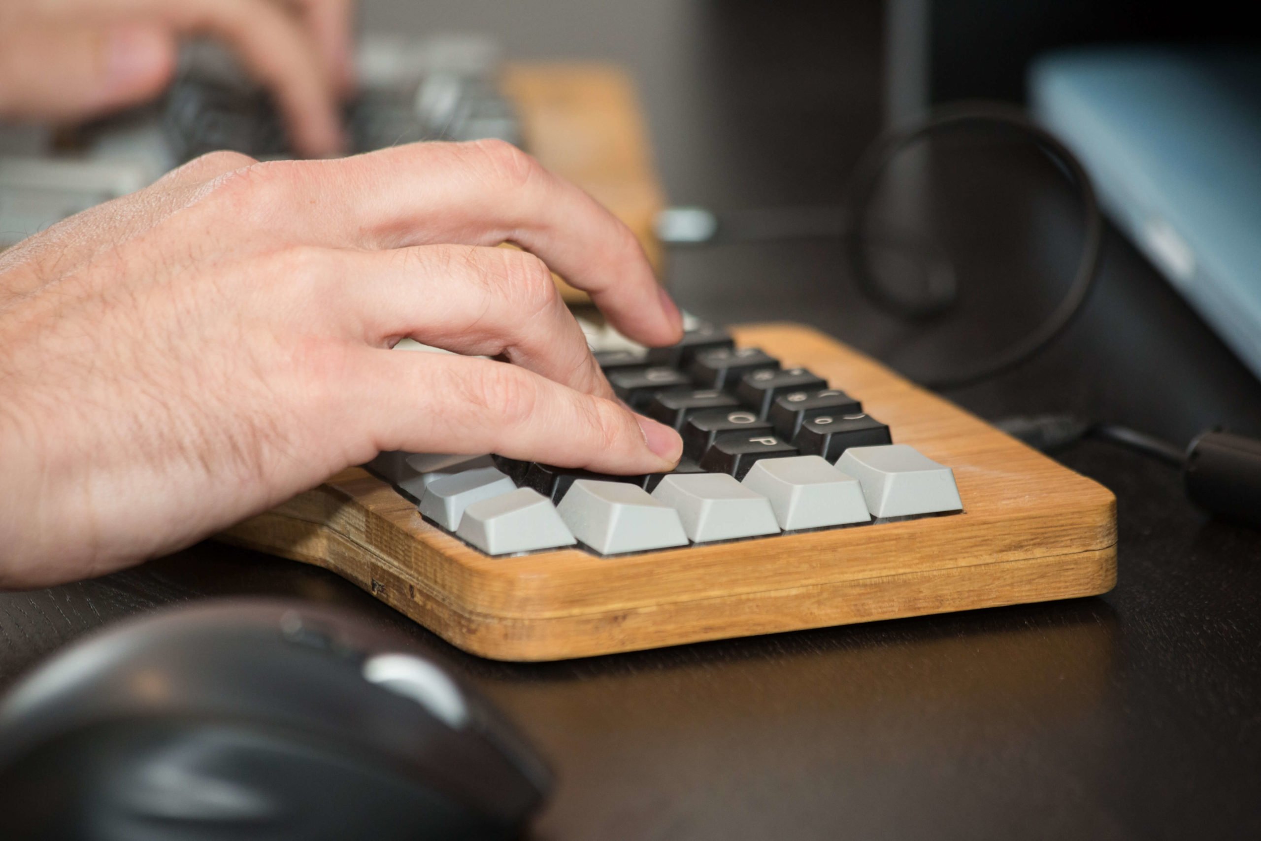 close up of hands on a wooden keyboard