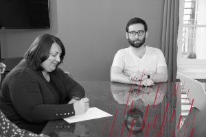 two employees at a conference table