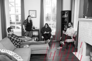 four employees socializing in the office living room