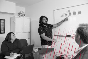 man presenting on a white board
