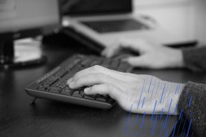 close up of hands on a keyboard