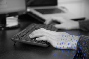 close up of hands on a keyboard
